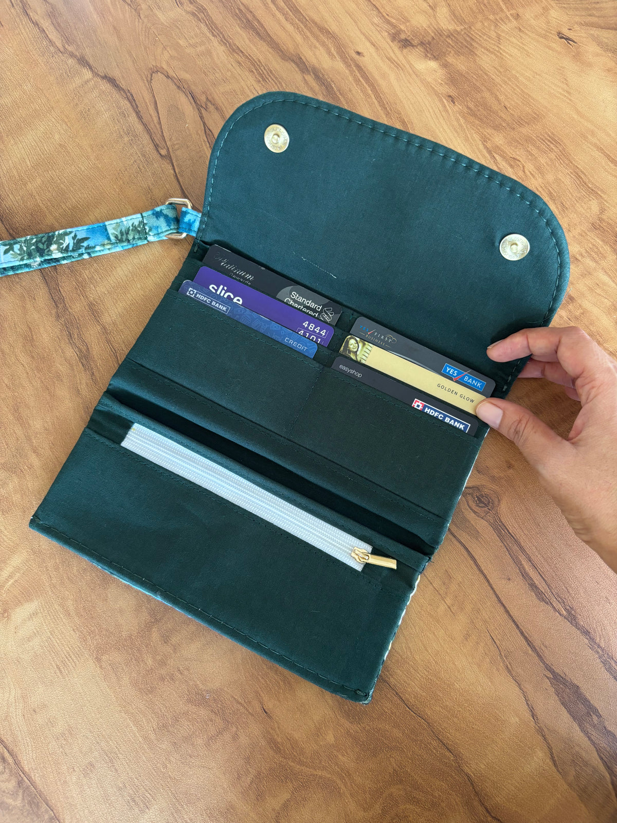 Lakeside Garden fold up wallet open, showing card slots, a zip pocket and the green lining