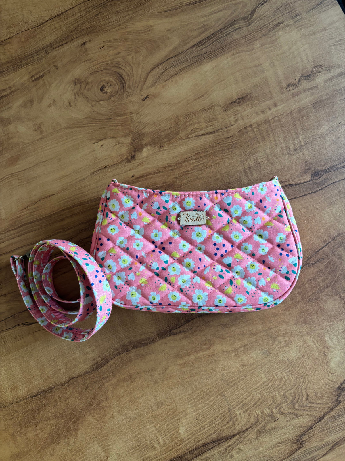 Pink Daisy Quilted Baguette Bag lying flat with its matching strap