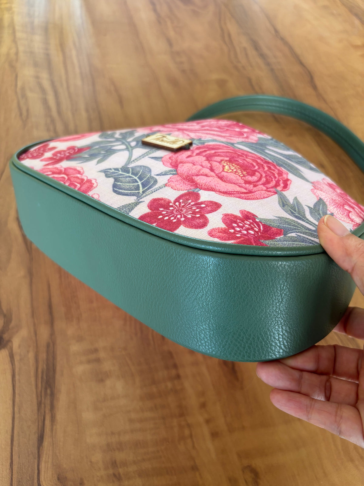 Peony Garden Baguette Bag from below, showing the sage green faux leather and strap