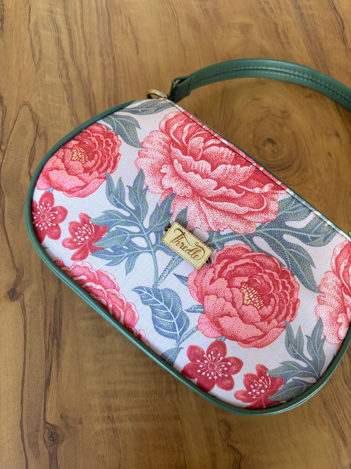 Close-up of the Peony Garden Baguette Bag front with the Thredle tag