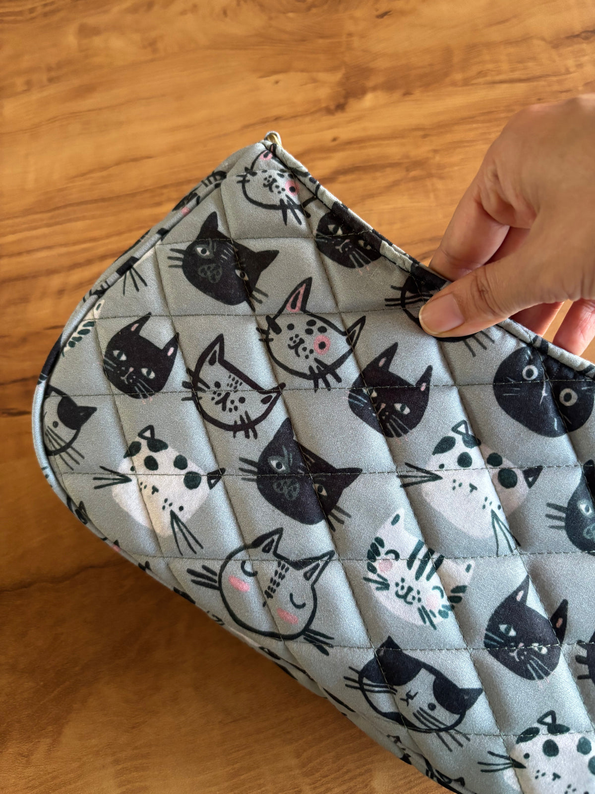Close-up of the quilted cat-face print
