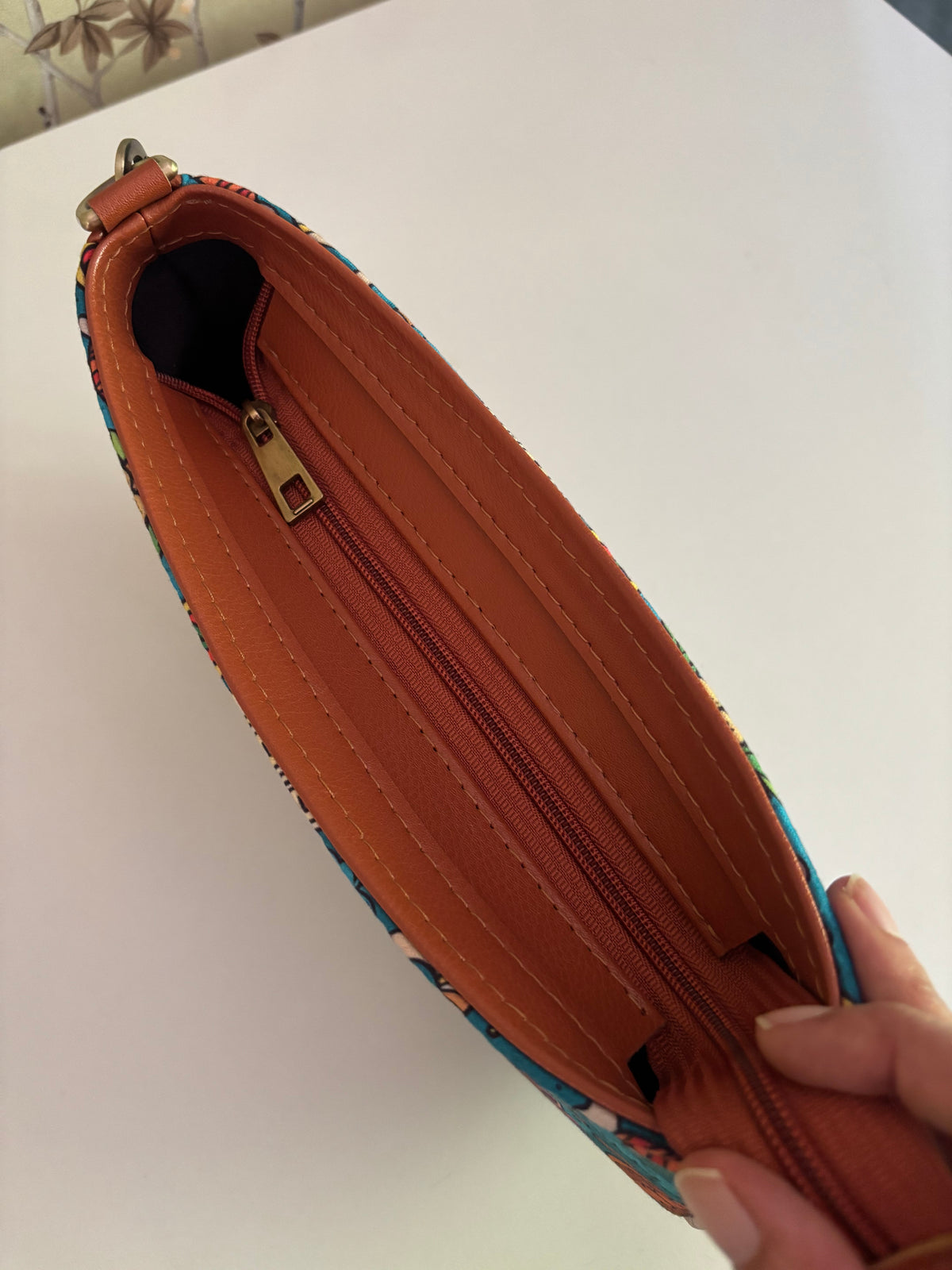 Inside the India Print Baguette Bag: roomy, lined in tan, with a zip closure